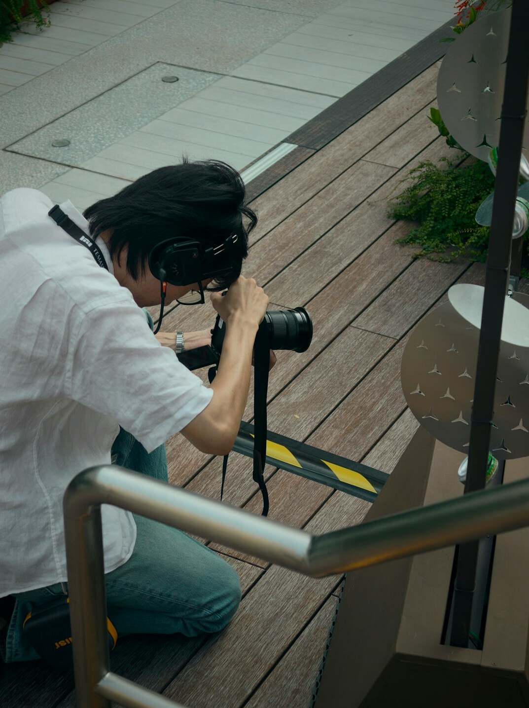Camera operator filming with a broadcast camera on a pedestal